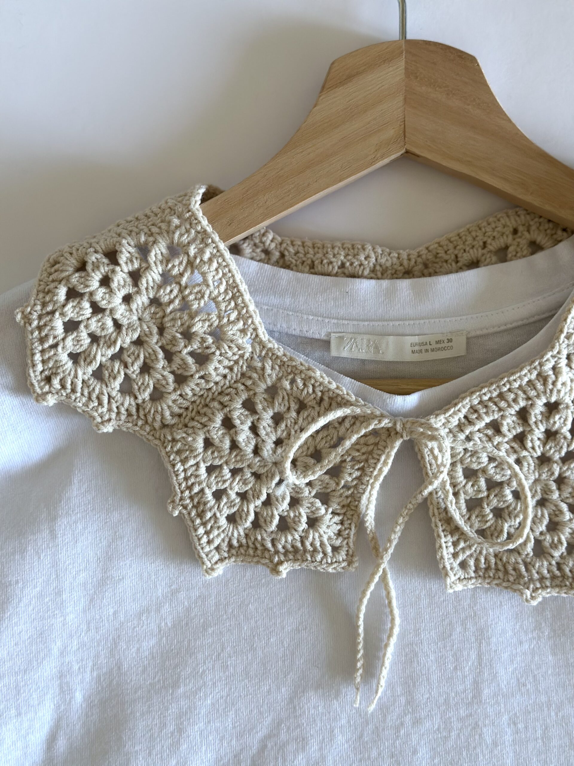 beżowy kołnierzyk zrobiony na szydełku. wiązany z przodu na troczki,