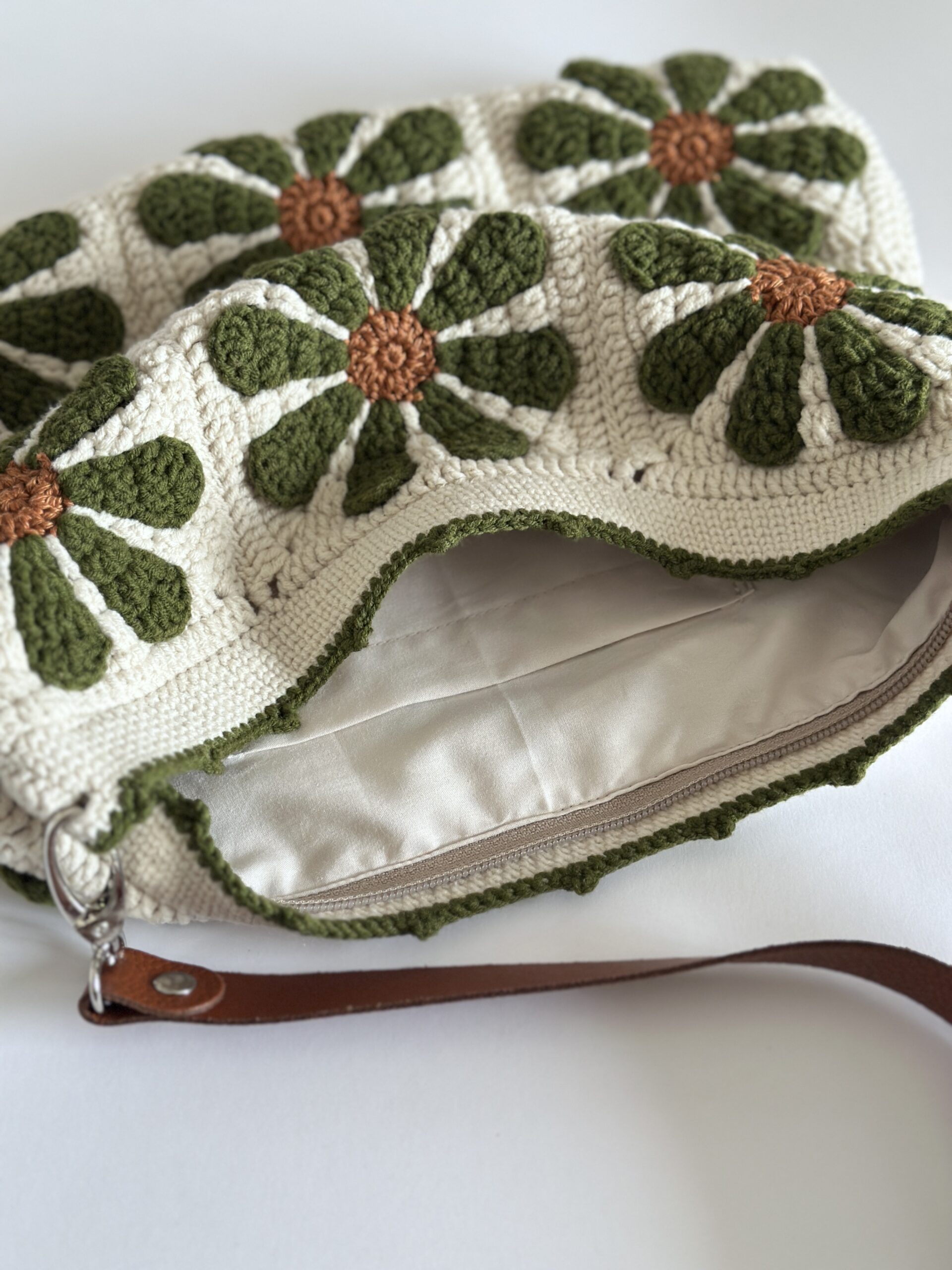 Szydełkowa torebka podszewką zapinana na zamek. pasek skórzany z możliwością regulacji długości. po odpięciu paska można prac w pralce. kolory to beż, oliwka i cynamon.